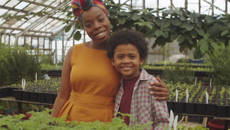 Portrait-of-Joyous-African-American-Mother-and-Son-in-Greenhouse